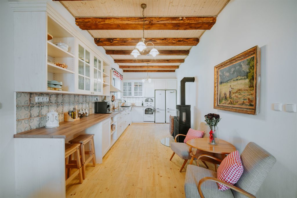 Main kitchen of Polňačka Cottage with beamed ceiling and a seating corner