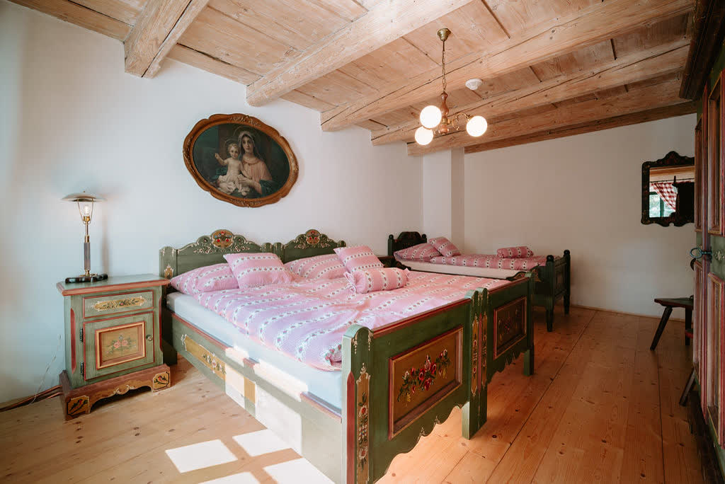 Bedroom with hand-painted folk beds at Polňačka Cottage