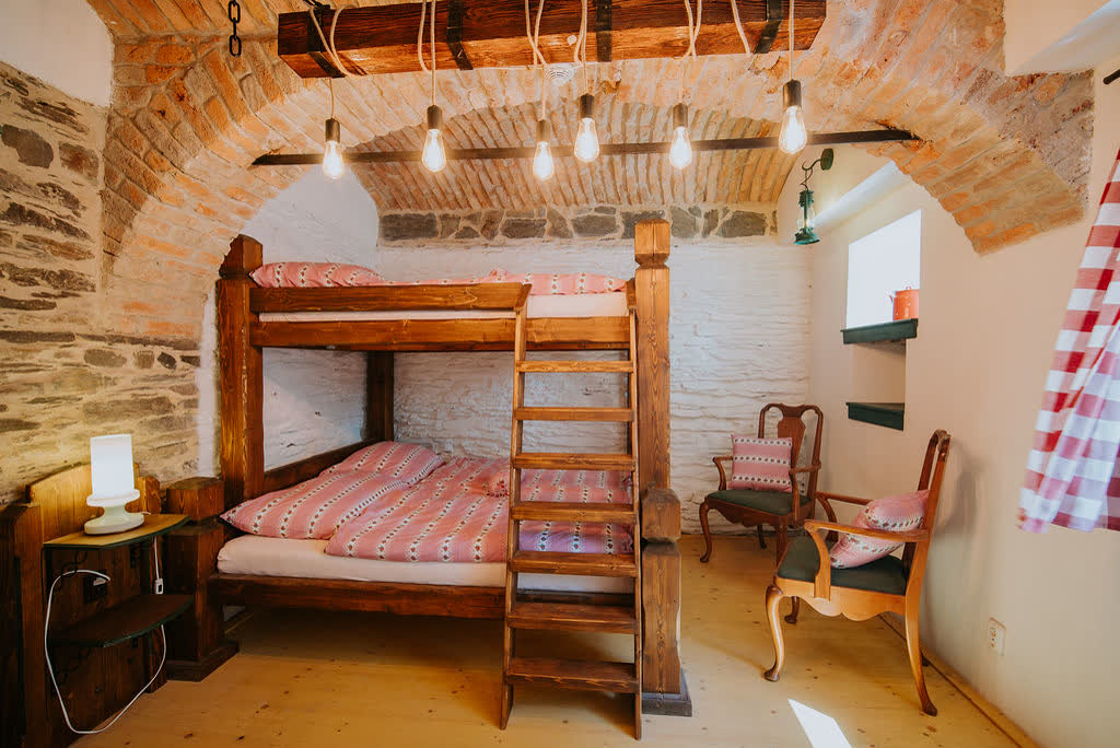 Bunk beds under a stone vault