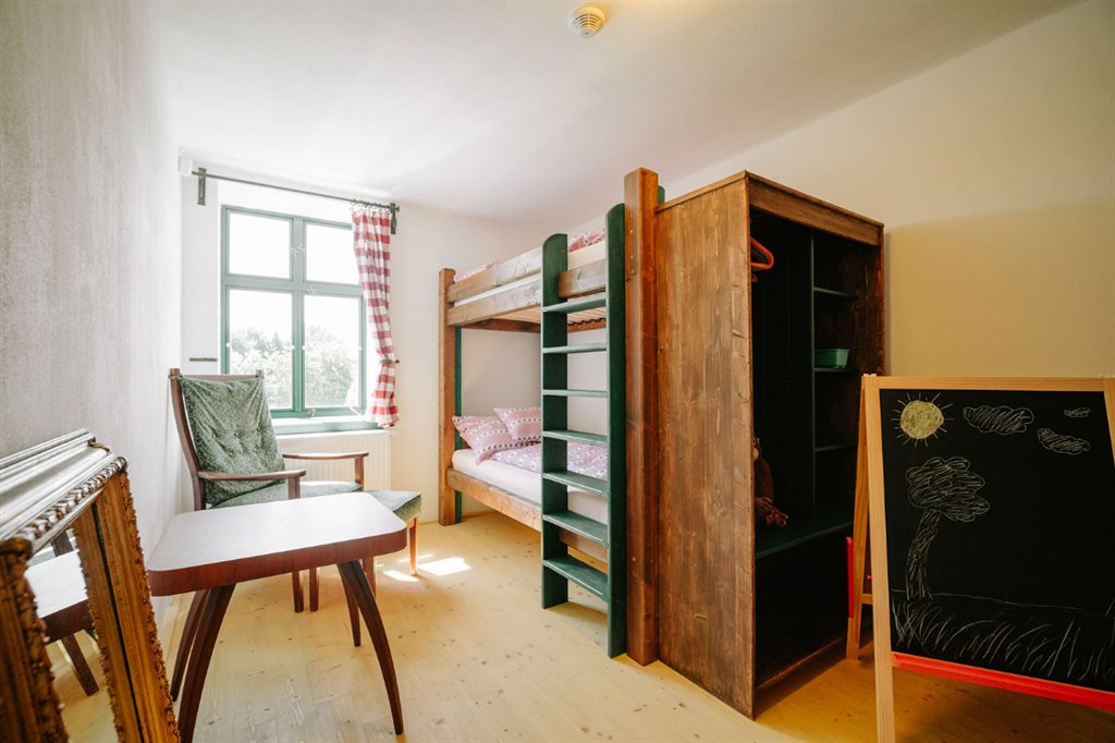 Children's room with a bunk bed and a chalkboard