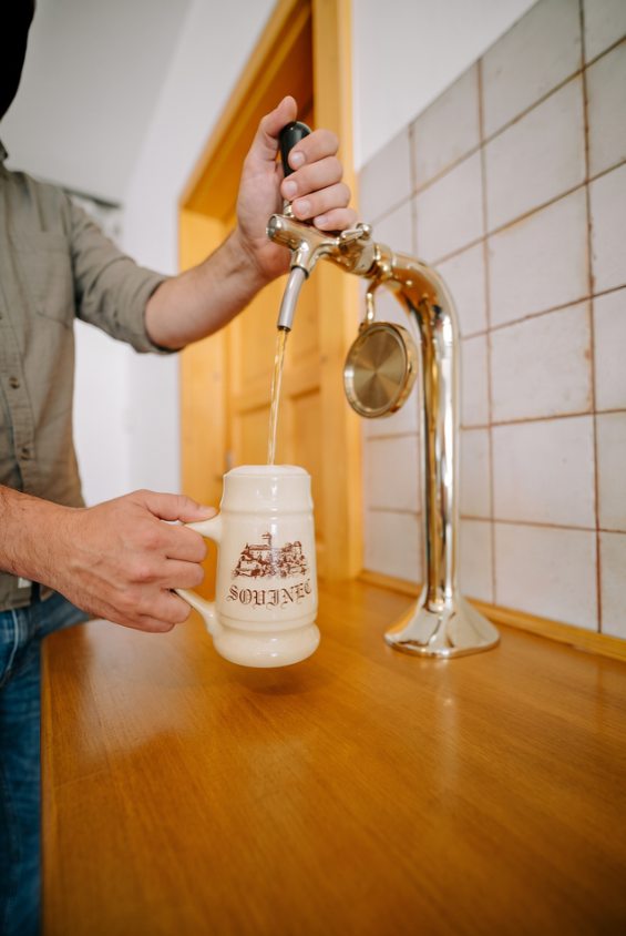 Pouring beer into a ceramic mug