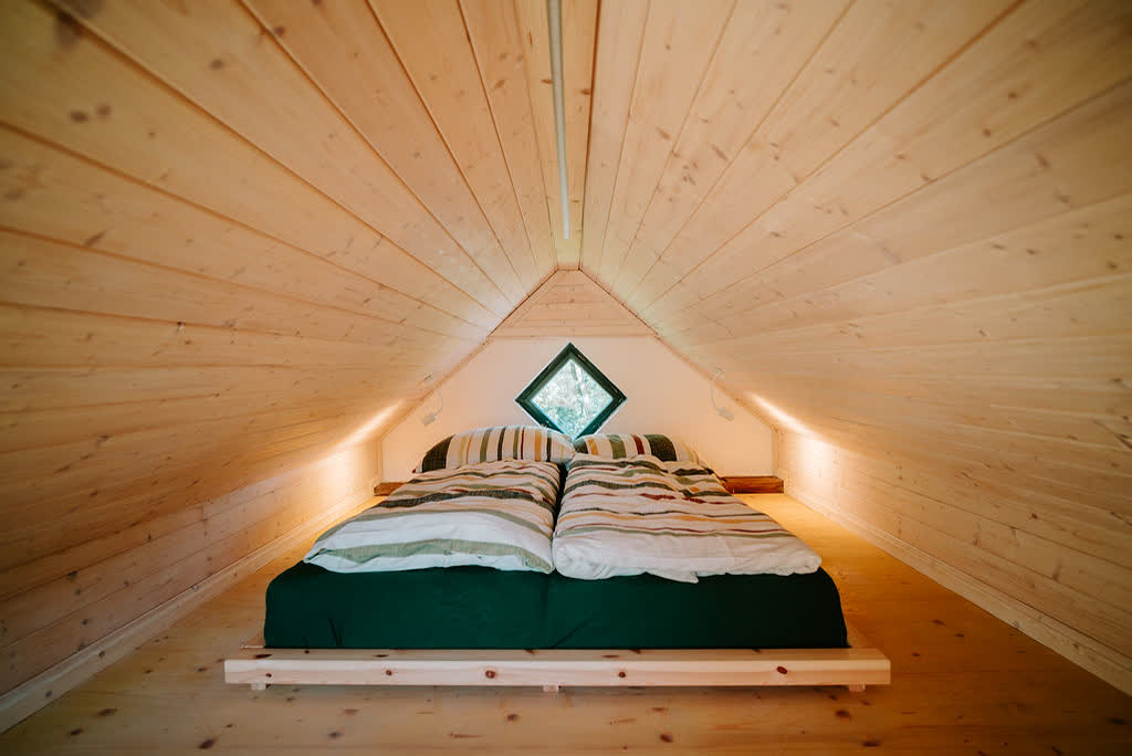 Bed under the timber roof