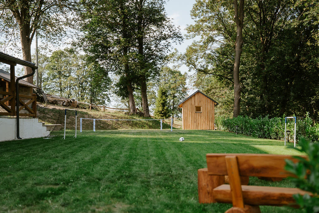 Large garden with a playground at Polňačka Cottage